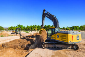 Heavy equipment operating on an active construction jobsite during peak construction season