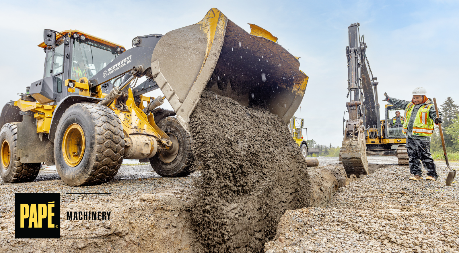 Construction crew and heavy equipment operating safely on a busy jobsite during peak construction season