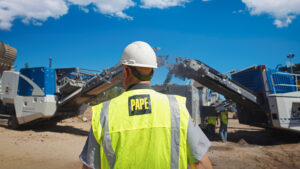 Papé Machinery Construction & Forestry team member overseeing Wirtgen Group roadbuilding equipment at an active construction site.