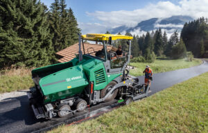 Vögele SUPER 1803-3i asphalt paver laying fresh pavement during a road construction project.
